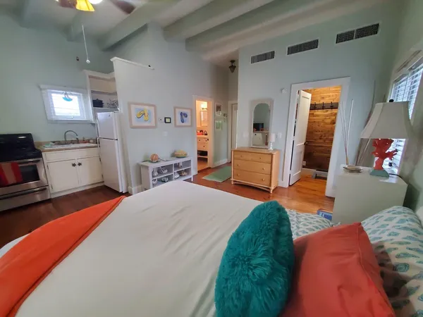 a bedroom with a bed and wooden floor