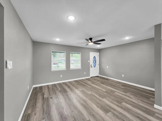 a view of an empty room and wooden floor