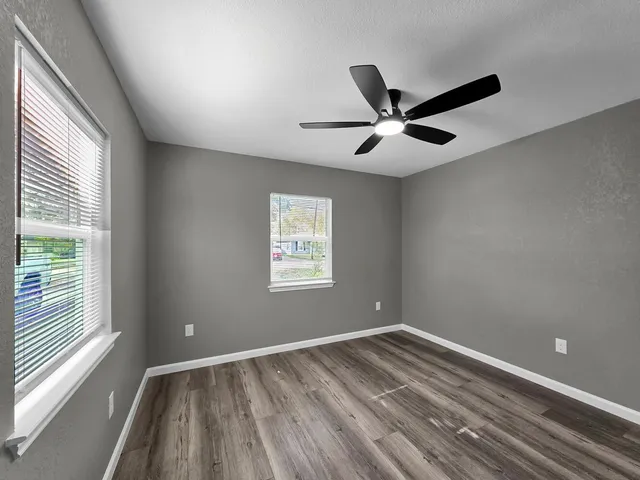 an empty room with closet and a window