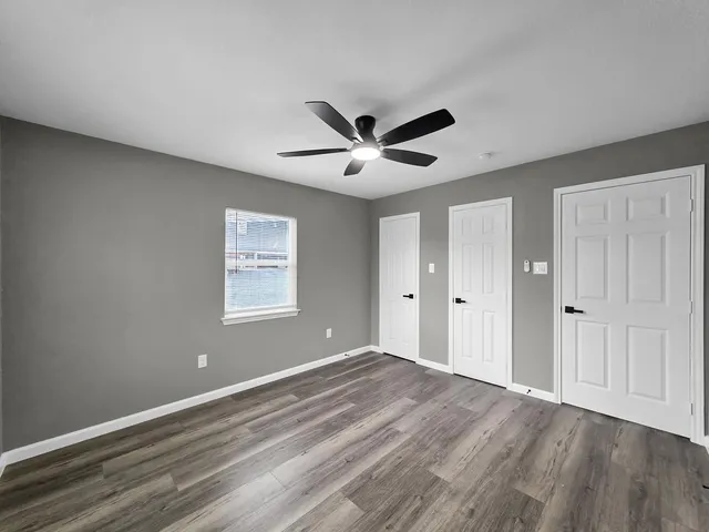 a view of brick house with a yard