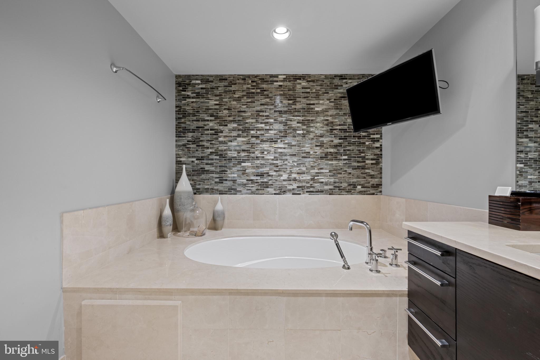 801 Key Highway, Unit 458 Baltimore, MD 21230 - Photo 26 of 48 a bathroom with a sink and a mirror