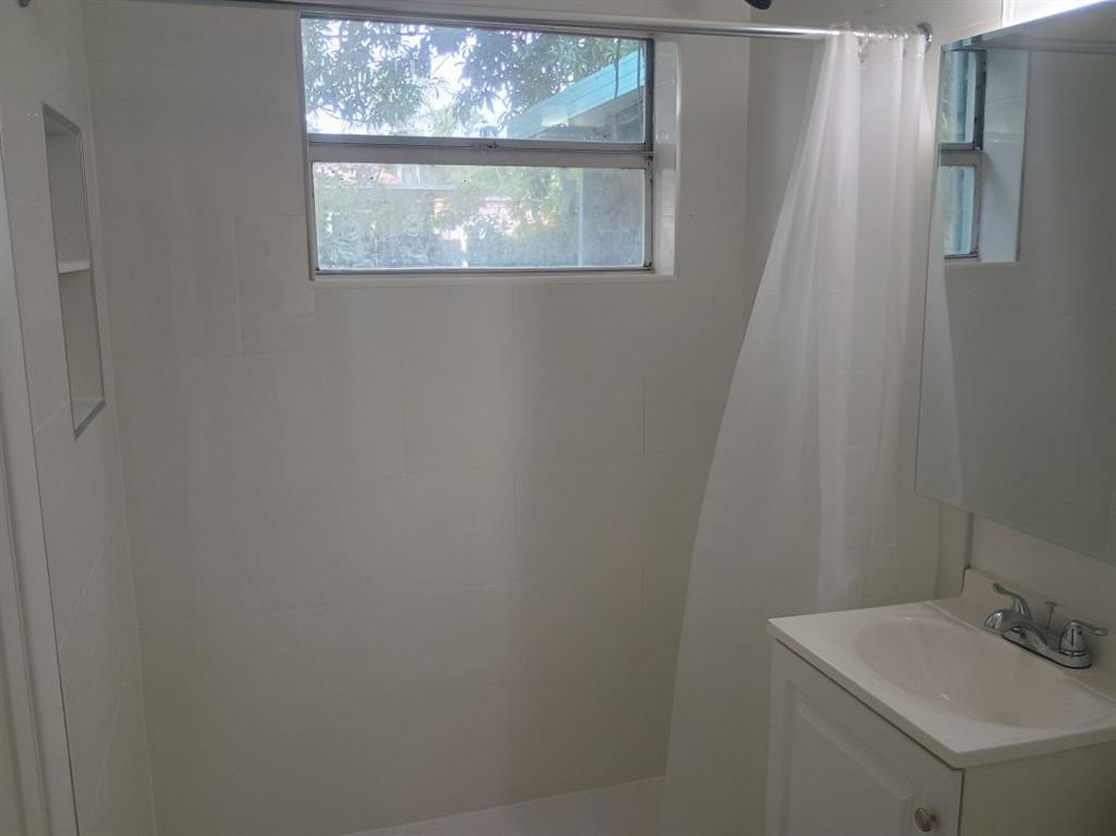 2465 Northeast 14th Avenue Pompano Beach, FL 33064 - Photo 4 of 6 a bathroom with a sink and a window