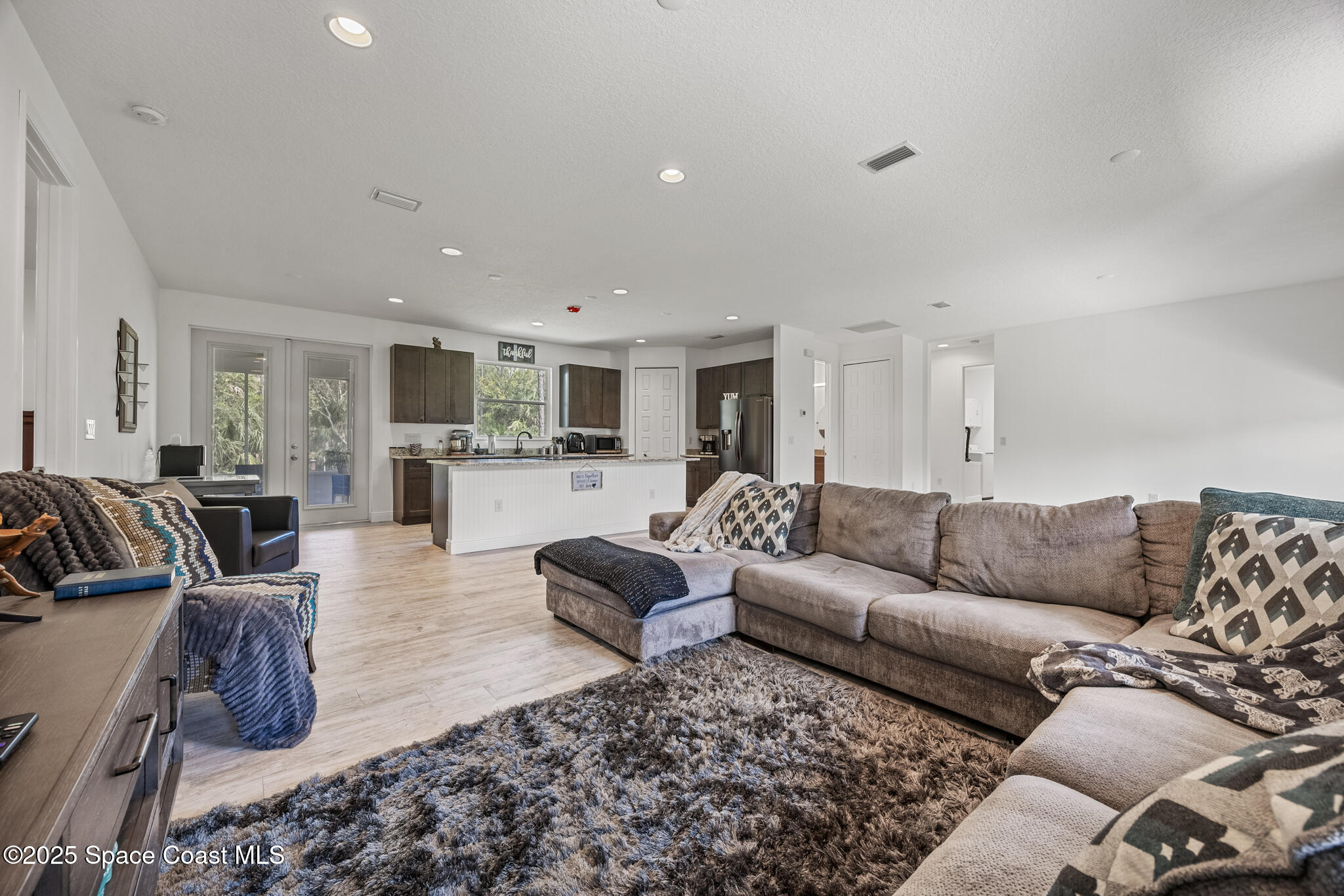 2050 Valkaria Road Grant-Valkaria, FL 32950 - Photo 14 of 56 a living room with furniture and view of kitchen