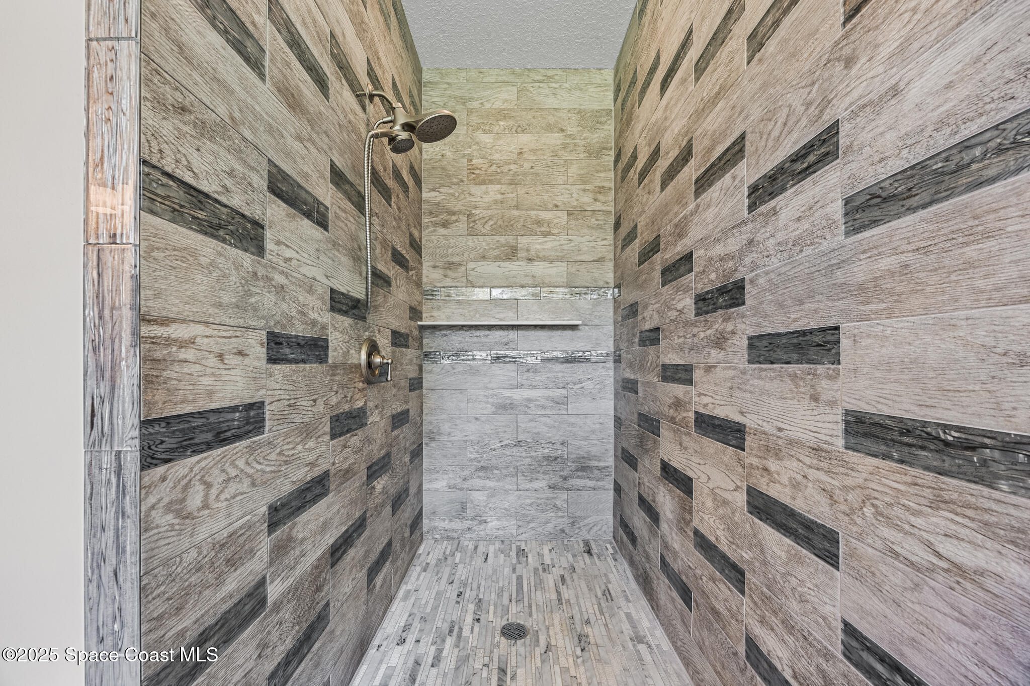 2050 Valkaria Road Grant-Valkaria, FL 32950 - Photo 18 of 56 a bathroom with a wooden floor and a shower