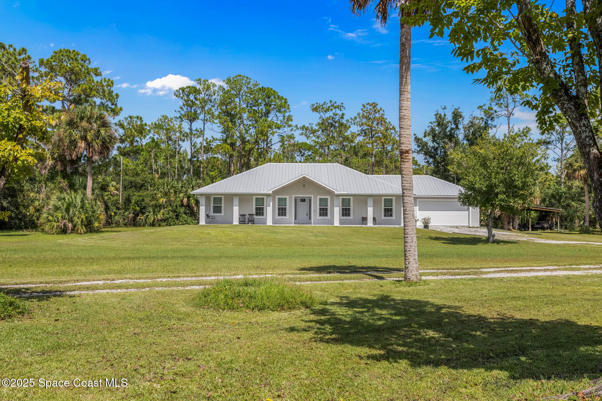2050 Valkaria Road Grant-Valkaria, FL 32950 - Photo 2 of 56 a view of a house with a big yard
