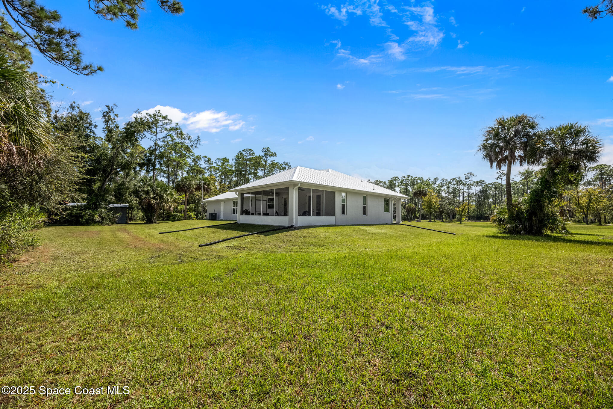 2050 Valkaria Road Grant-Valkaria, FL 32950 - Photo 22 of 56 a yellow house with trees in the background