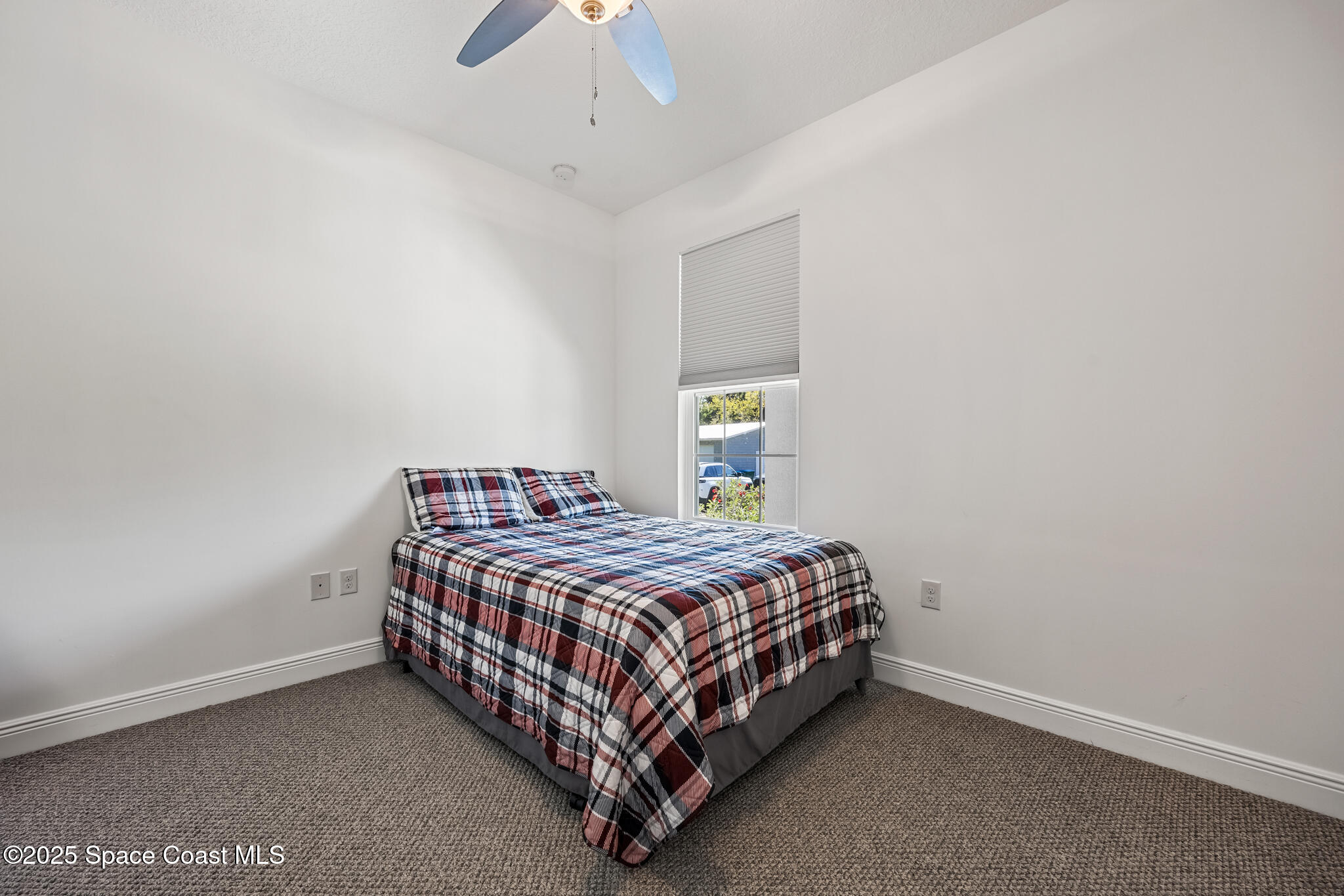 2050 Valkaria Road Grant-Valkaria, FL 32950 - Photo 23 of 56 a bedroom with a bed and a chandelier