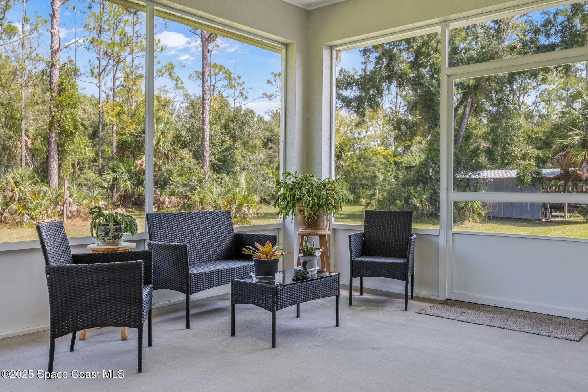 2050 Valkaria Road Grant-Valkaria, FL 32950 - Photo 29 of 56 a balcony with furniture and a potted plant