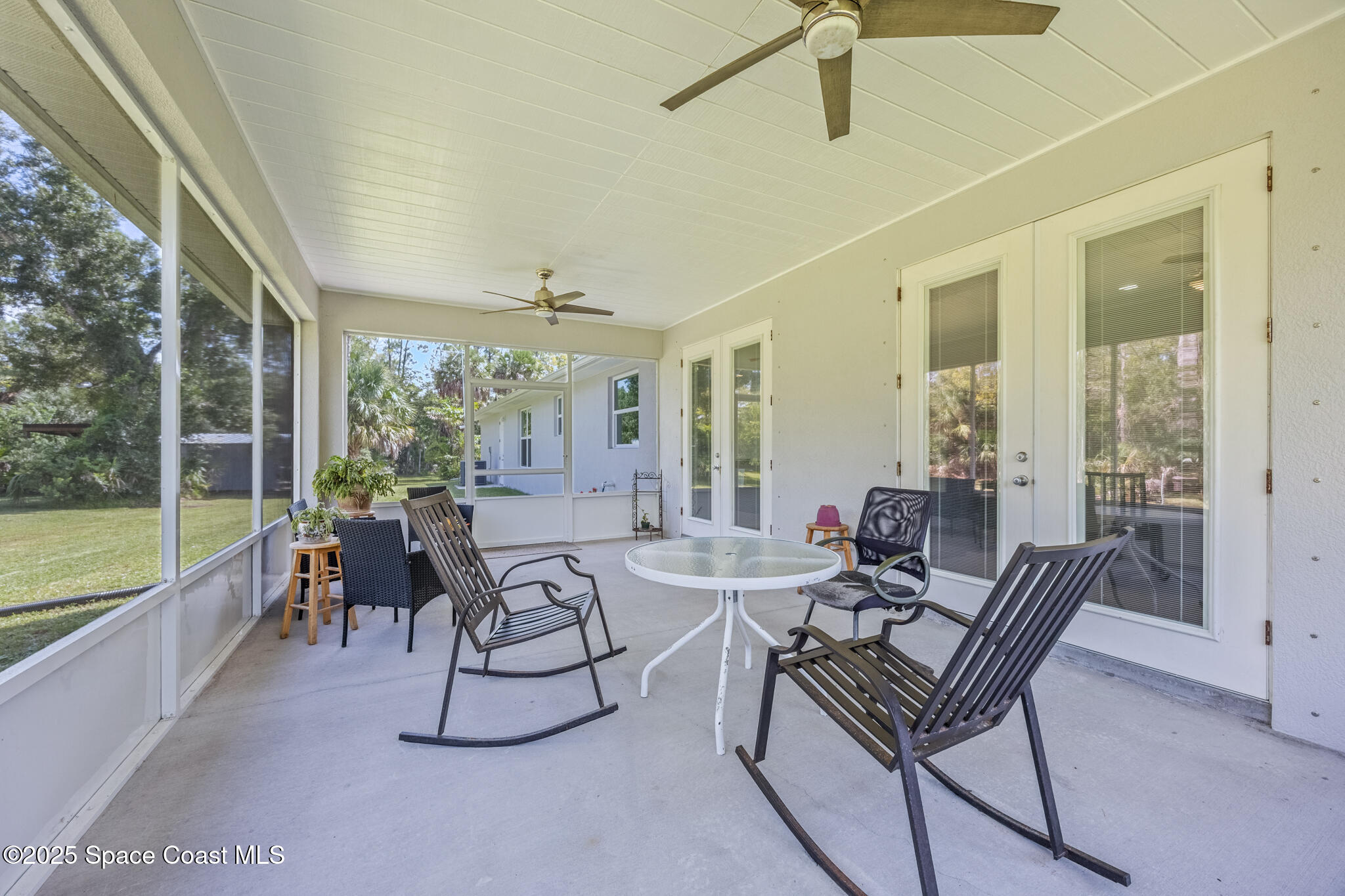 2050 Valkaria Road Grant-Valkaria, FL 32950 - Photo 30 of 56 a dining room with furniture and large windows