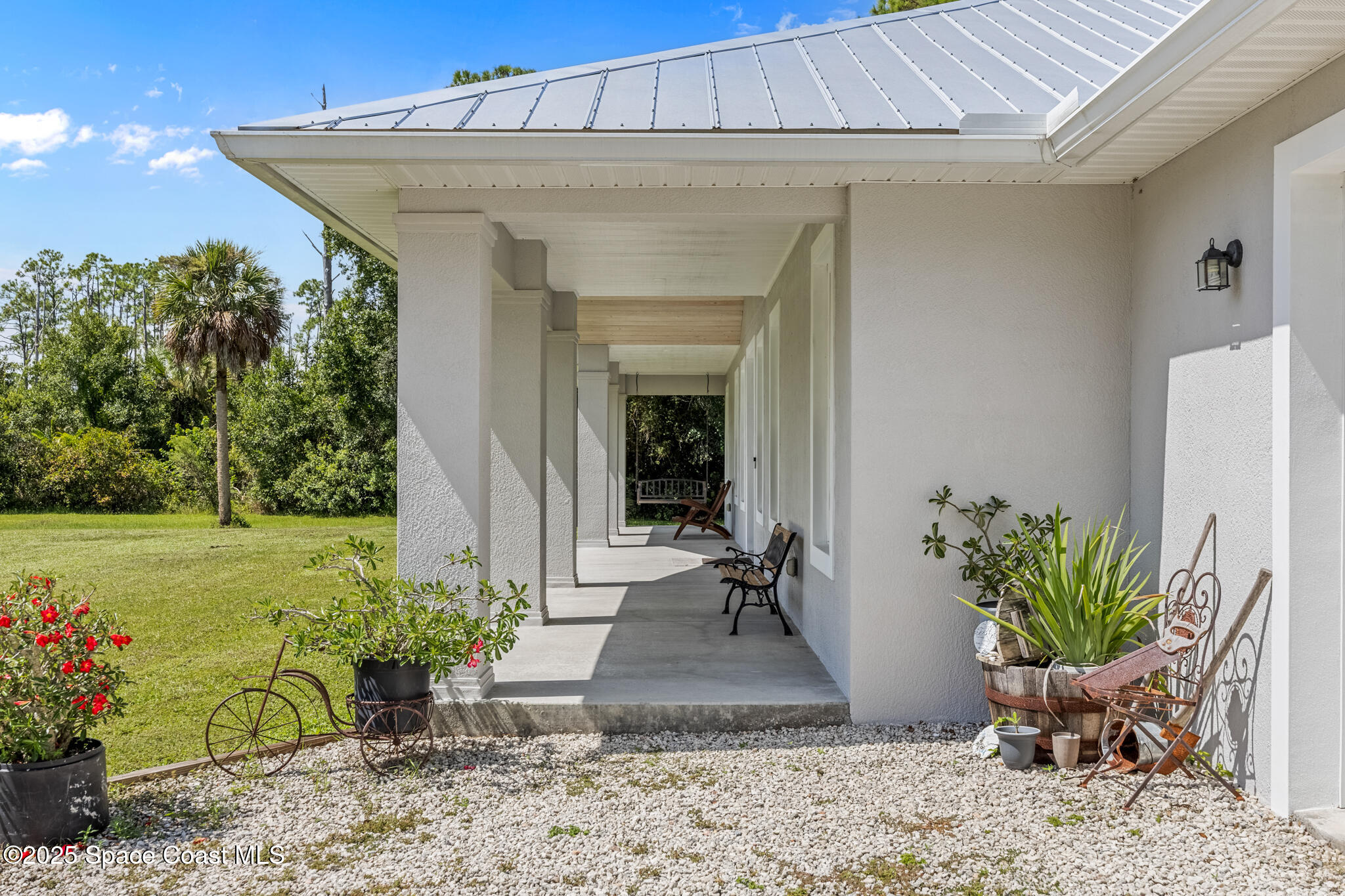 2050 Valkaria Road Grant-Valkaria, FL 32950 - Photo 3 of 56 a view of a entryway door with potted plants