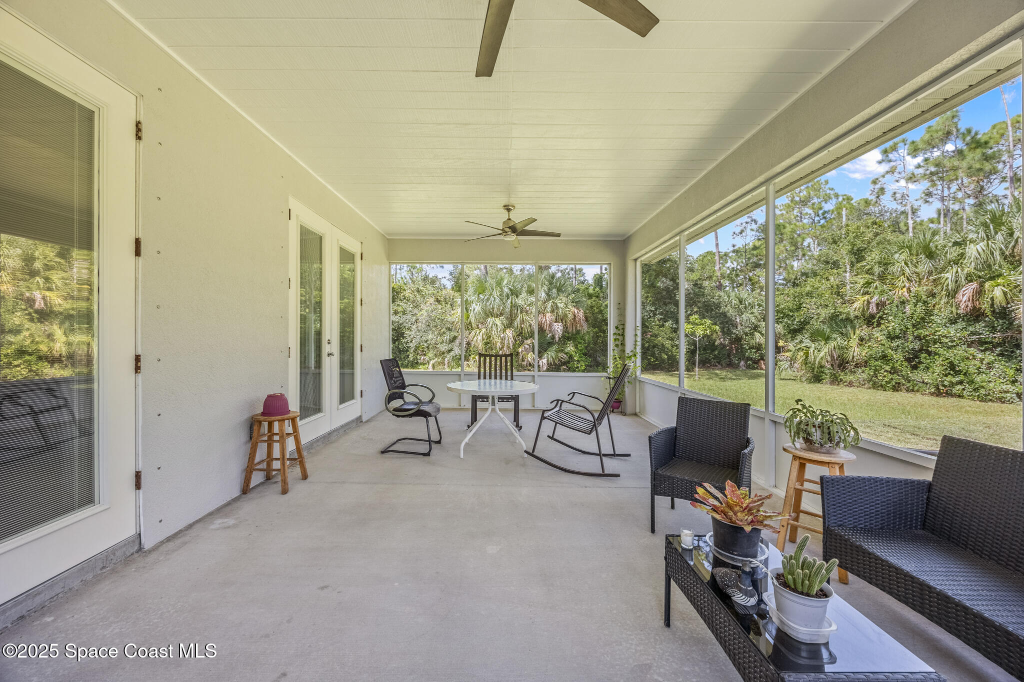 2050 Valkaria Road Grant-Valkaria, FL 32950 - Photo 31 of 56 a living room with furniture and a floor to ceiling window