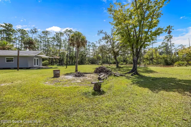 a view of a house with swimming pool and a yard