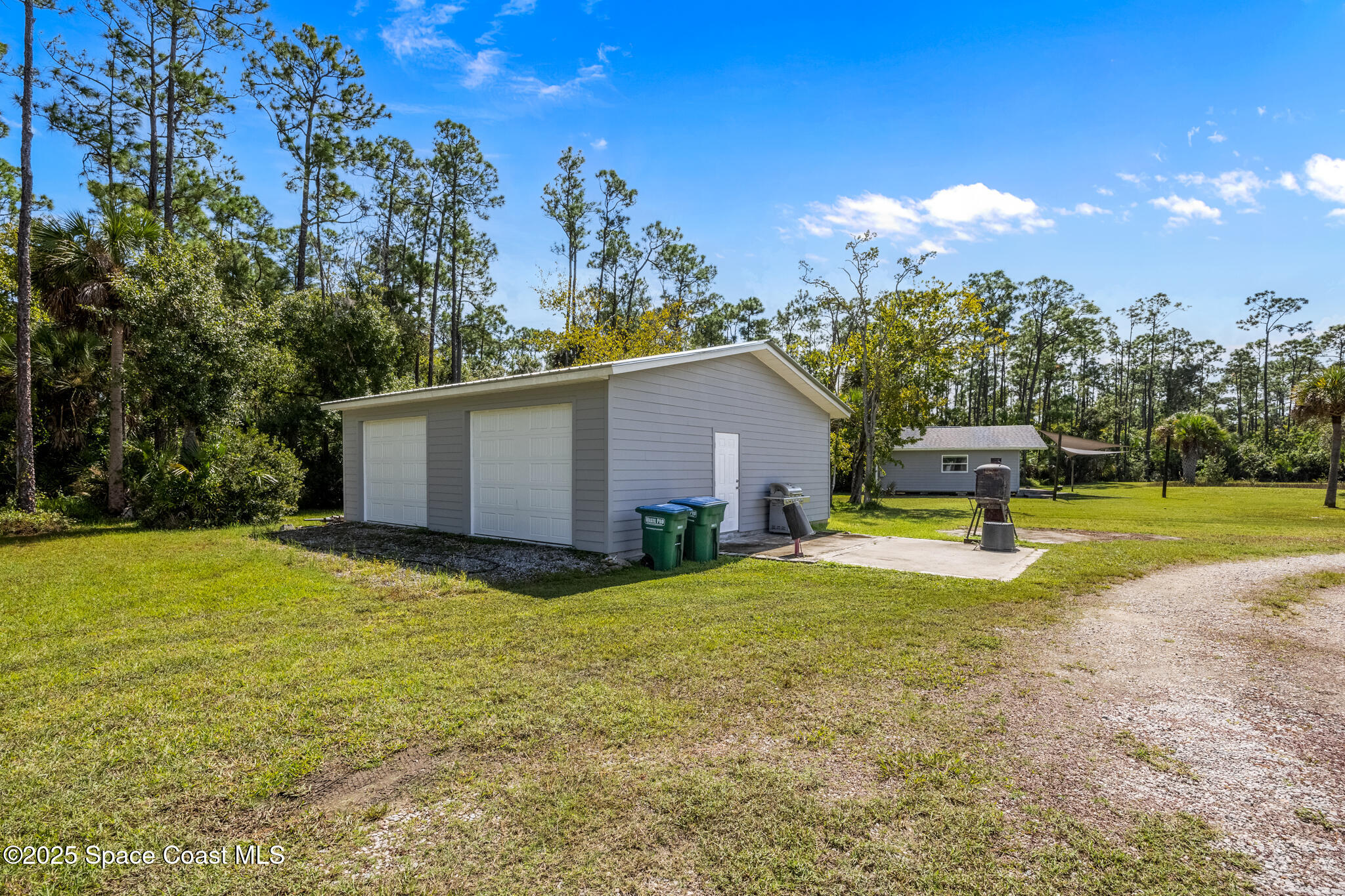 2050 Valkaria Road Grant-Valkaria, FL 32950 - Photo 34 of 56 a view of a house with swimming pool and a yard
