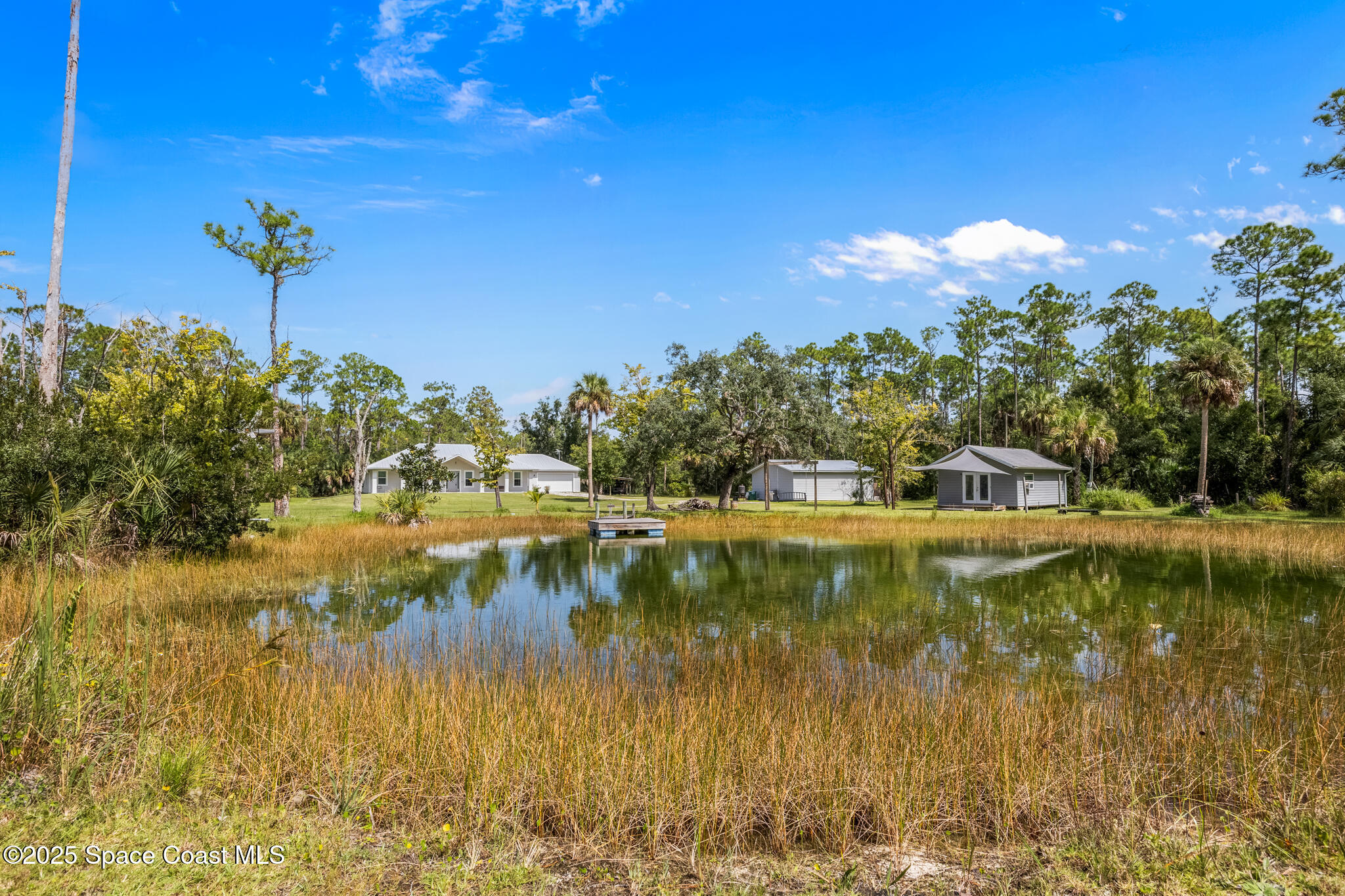 2050 Valkaria Road Grant-Valkaria, FL 32950 - Photo 47 of 56 a view of a lake with houses