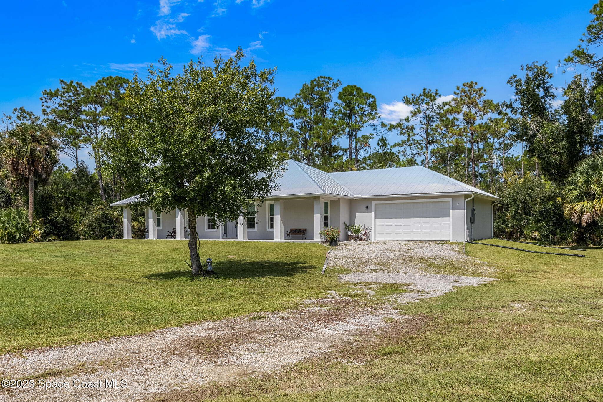 2050 Valkaria Road Grant-Valkaria, FL 32950 - Photo 56 of 56 a front view of a house with a garden