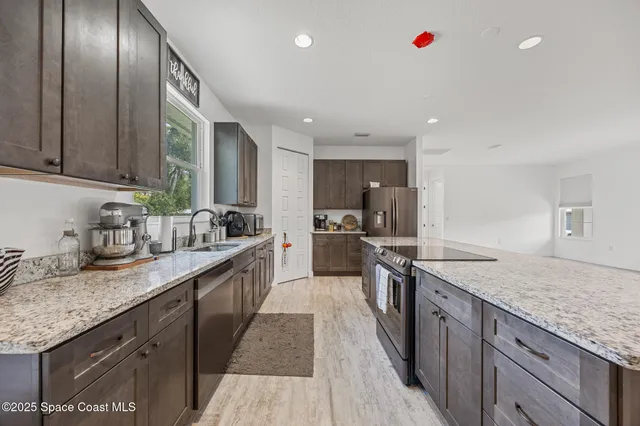 a large kitchen with granite countertop lots of counter space and window