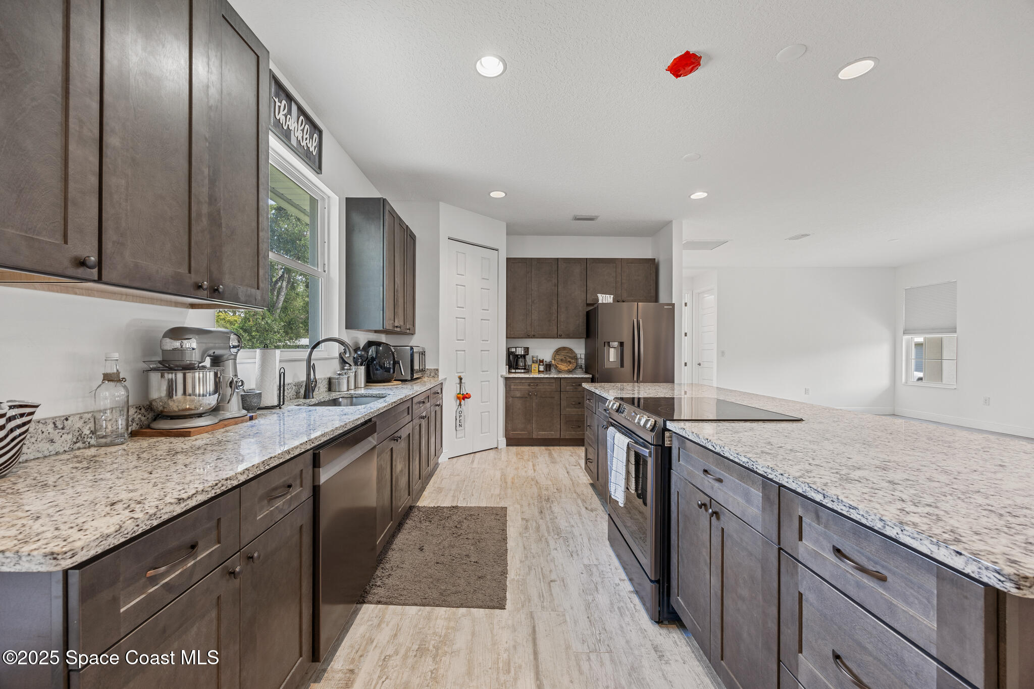 2050 Valkaria Road Grant-Valkaria, FL 32950 - Photo 10 of 56 a large kitchen with granite countertop lots of counter space and window