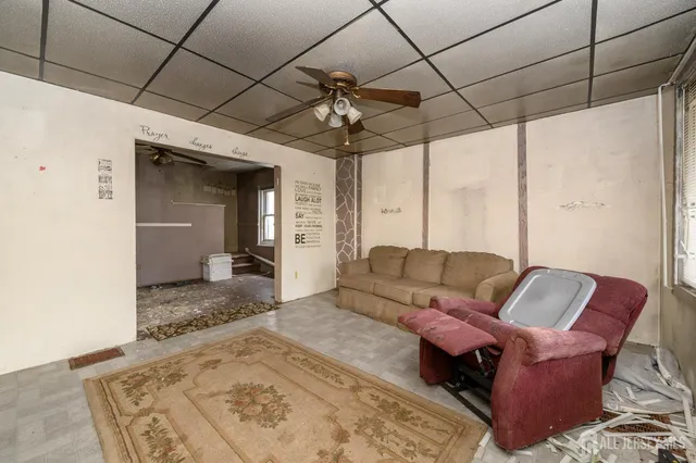 a living room with furniture and a chandelier
