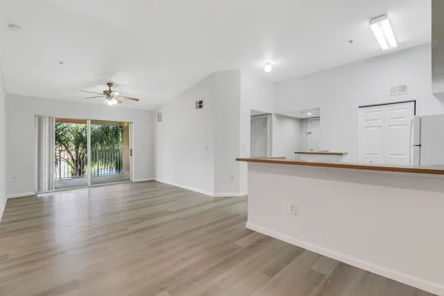 a view of a kitchen with a sink and a window
