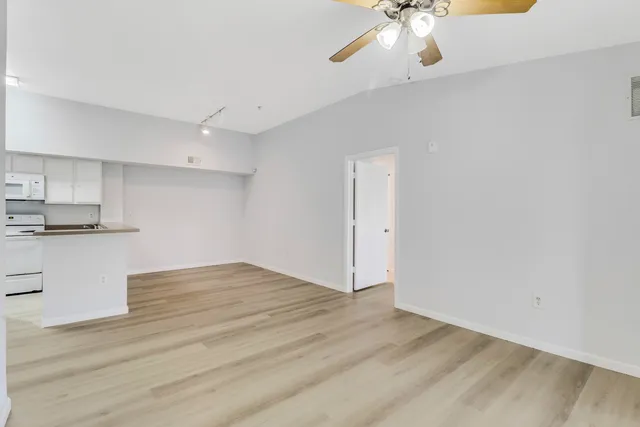 a view of kitchen with granite countertop cabinets and wooden floor
