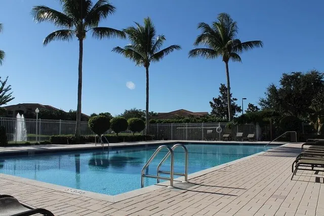 a view of swimming pool with a table and chairs