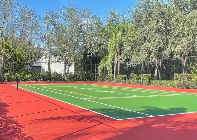 a view of tennis court with trees in the background