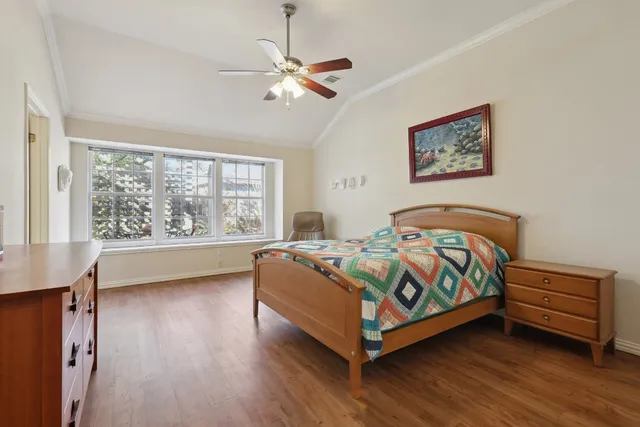 a bedroom with a bed and a large window