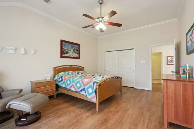 a bedroom with a bed and wooden floor