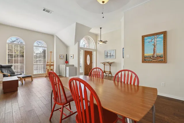 a view of a a dining room with furniture window and wooden floor