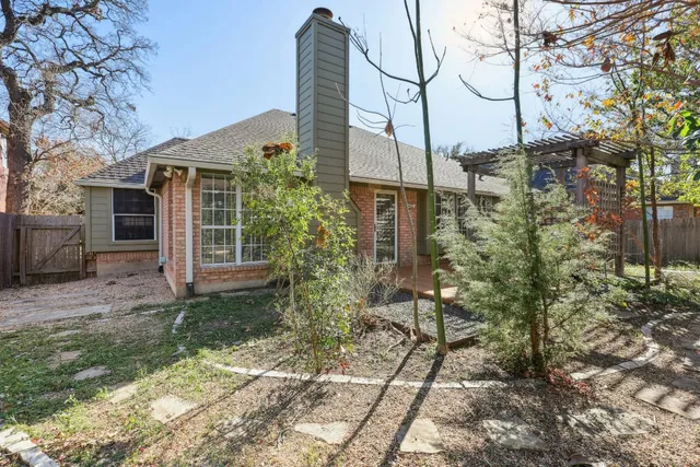 a backyard of a house with table and chairs