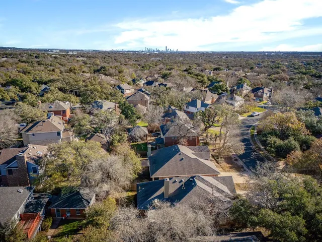 an aerial view of a house with yard