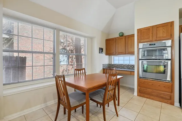 a dining room with furniture and a window