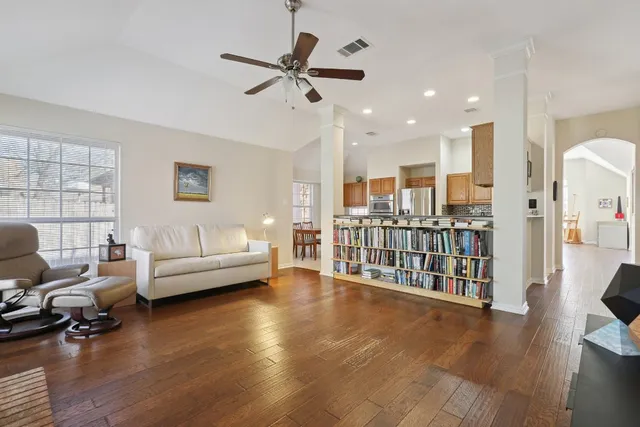 a living room with furniture and a wooden floor