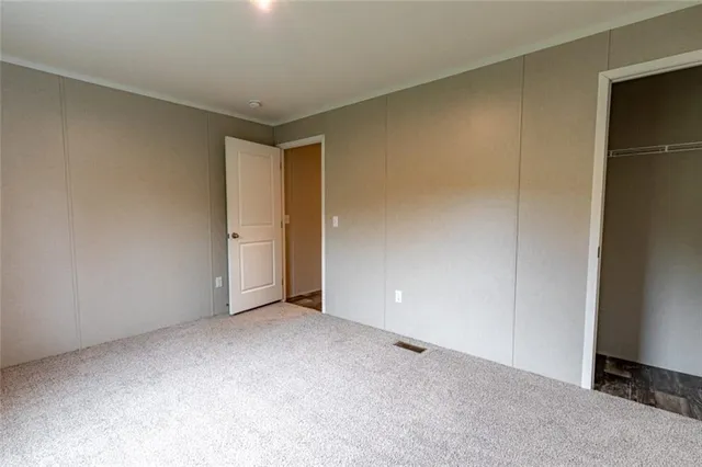 a view of an empty room and closet area
