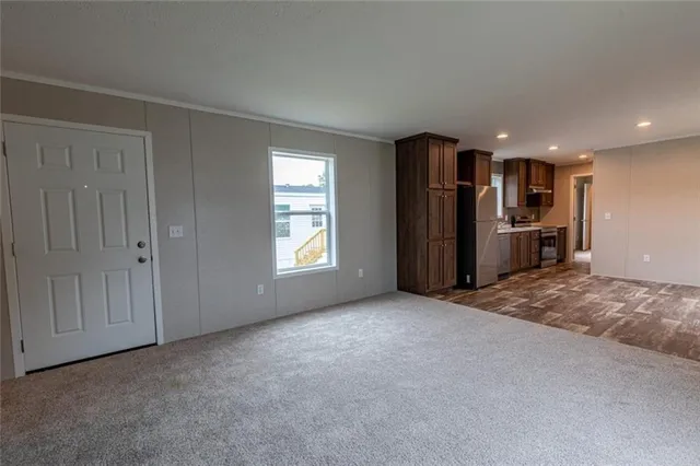 a view of a kitchen with refrigerator and window
