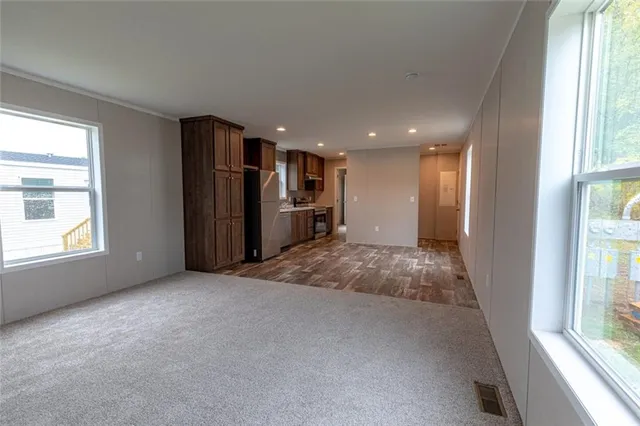 a view of entryway with wooden floor and windows