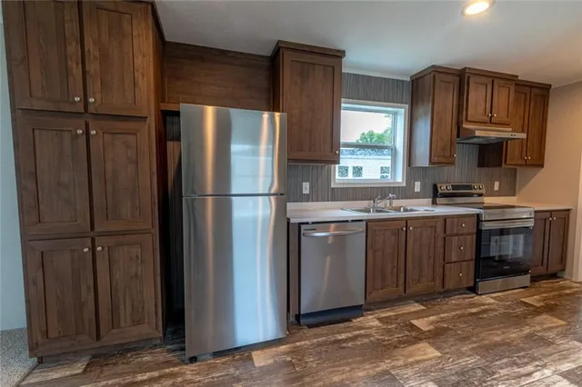 a kitchen with a refrigerator sink and cabinets