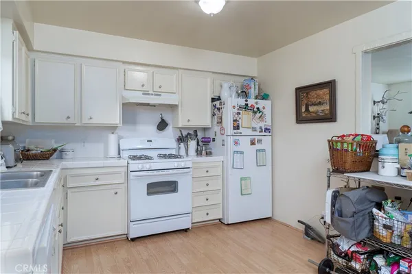 a kitchen with stainless steel appliances a stove and cabinets