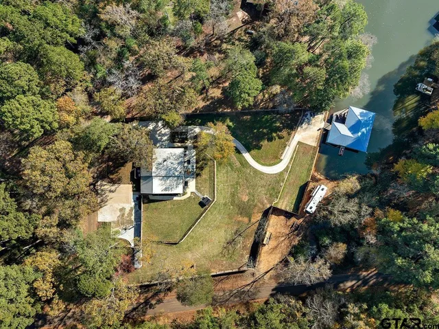 an aerial view of residential house with yard and outdoor seating