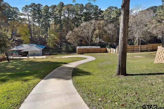 a view of a garden with lawn chairs