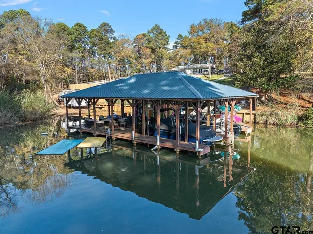 a swimming pool view with a seating space and a garden view
