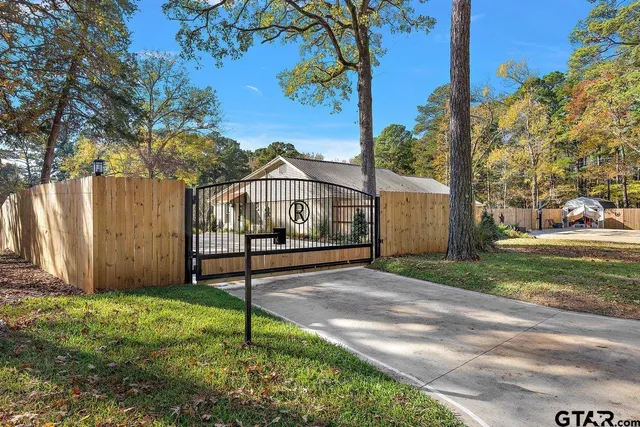 a sign board with flower garden in front of it