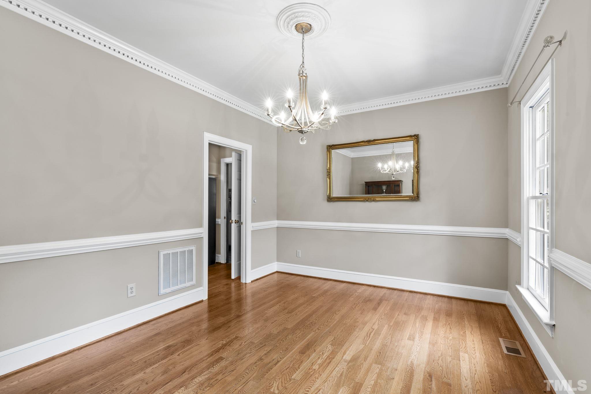 2821 Patrie Place Raleigh, NC 27613 - Photo 11 of 62 a view of an empty room with wooden floor and a window