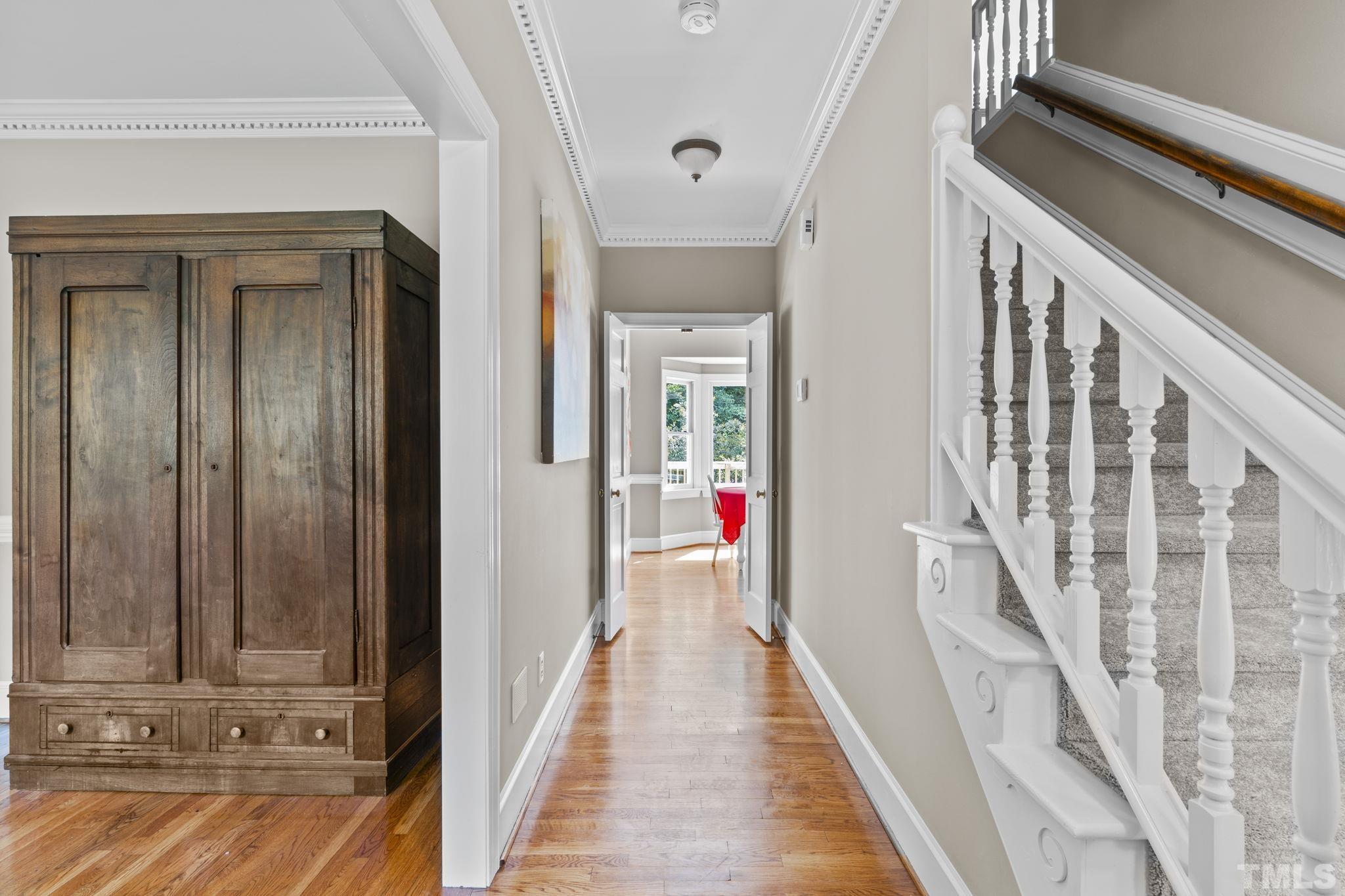 2821 Patrie Place Raleigh, NC 27613 - Photo 14 of 62 a view of a hallway with wooden floor and staircase