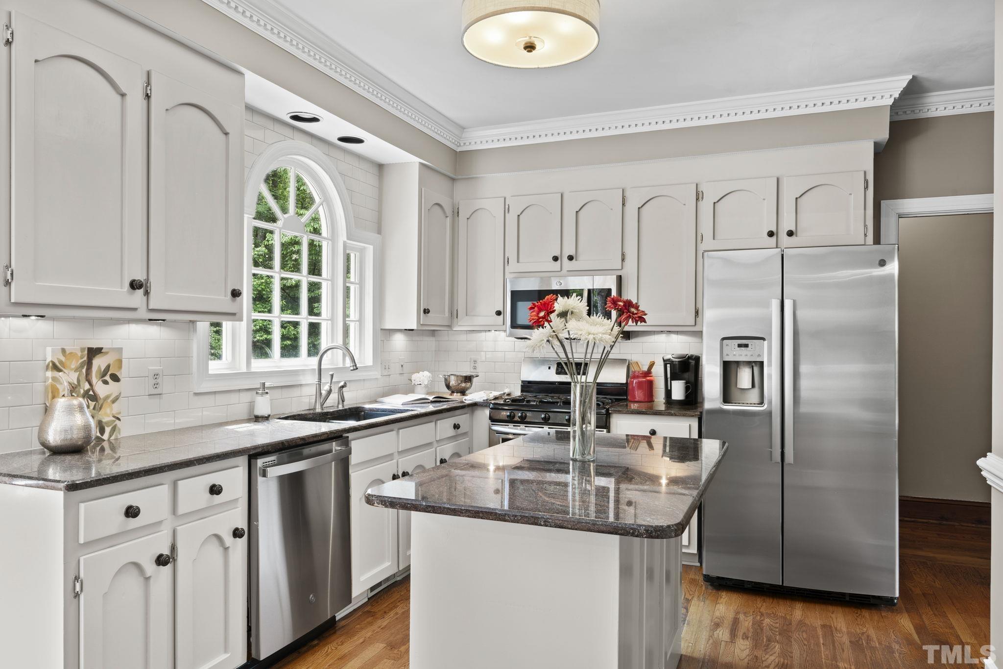 2821 Patrie Place Raleigh, NC 27613 - Photo 25 of 62 a kitchen with stainless steel appliances granite countertop a sink a window and cabinets
