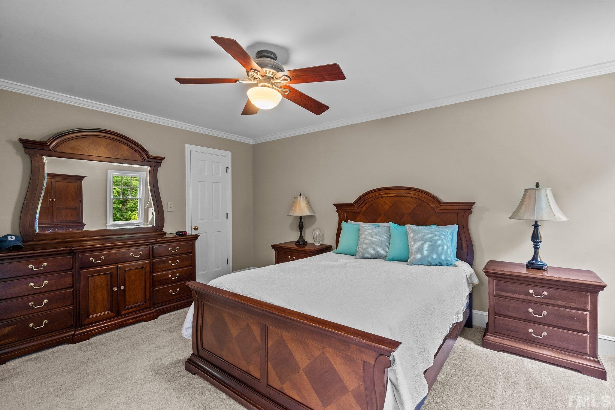 2821 Patrie Place Raleigh, NC 27613 - Photo 36 of 62 a bedroom with a bed and a dresser