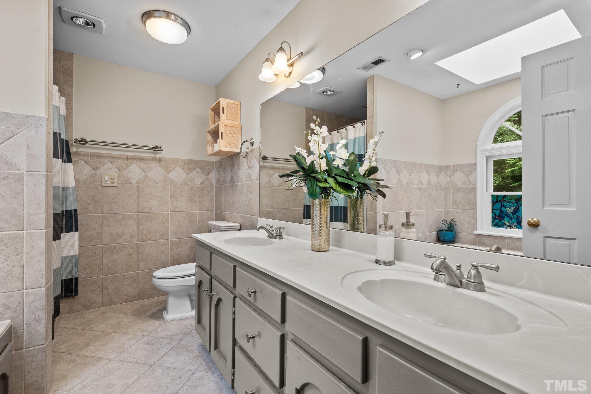 2821 Patrie Place Raleigh, NC 27613 - Photo 37 of 62 a bathroom with a sink double vanity and a toilet
