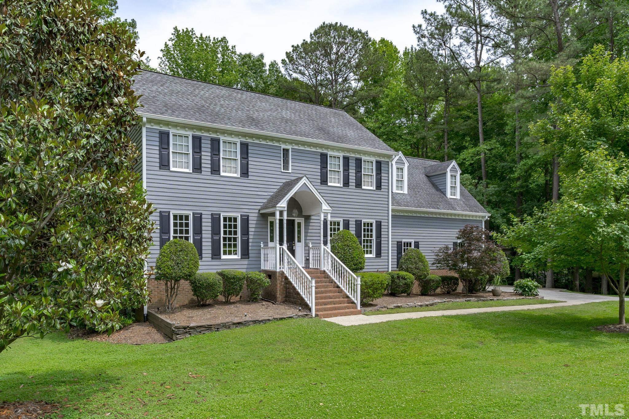 2821 Patrie Place Raleigh, NC 27613 - Photo 4 of 62 a front view of a house with a yard and green space