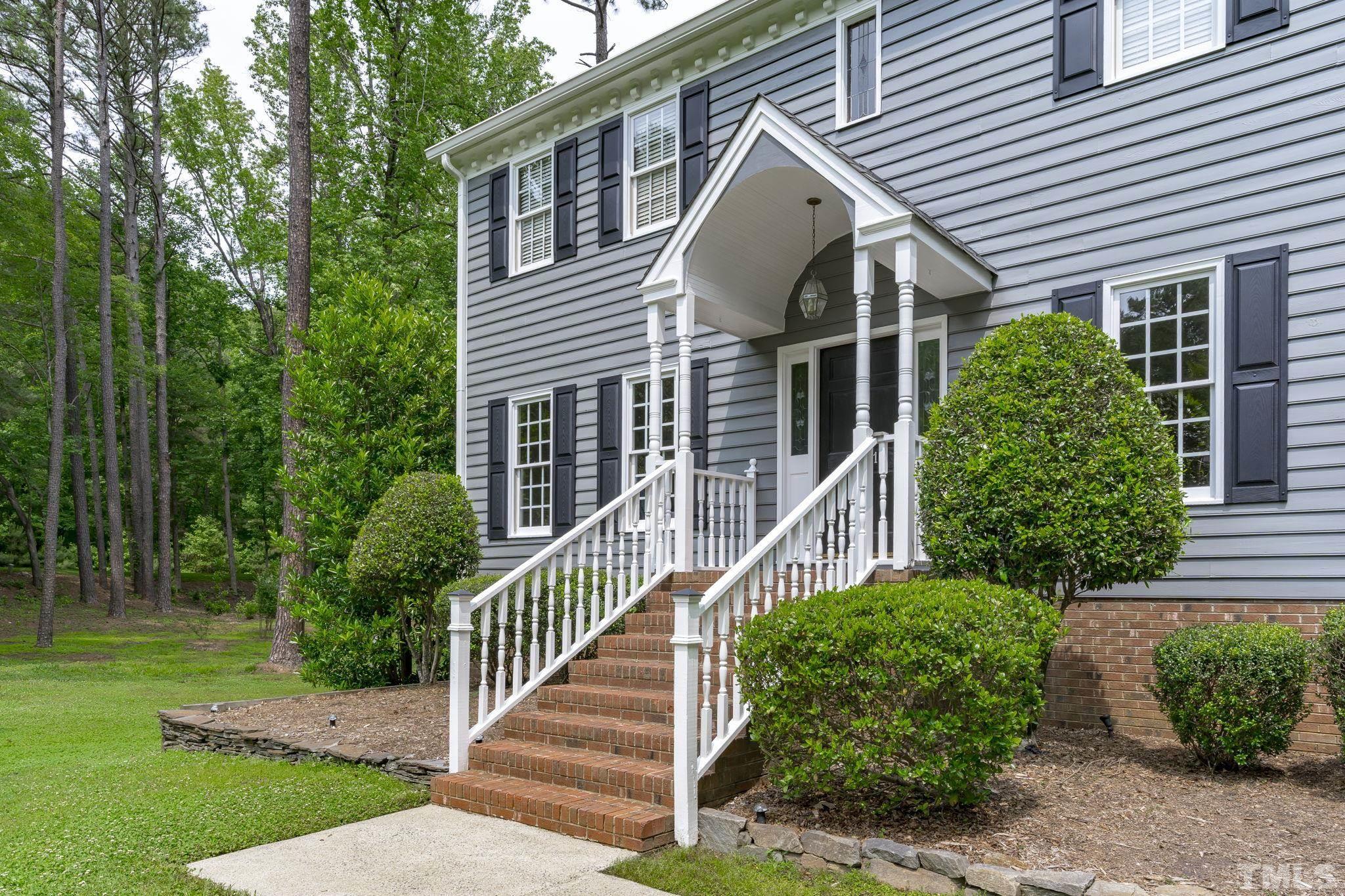 2821 Patrie Place Raleigh, NC 27613 - Photo 5 of 62 a view of a house with brick walls and a yard with plants