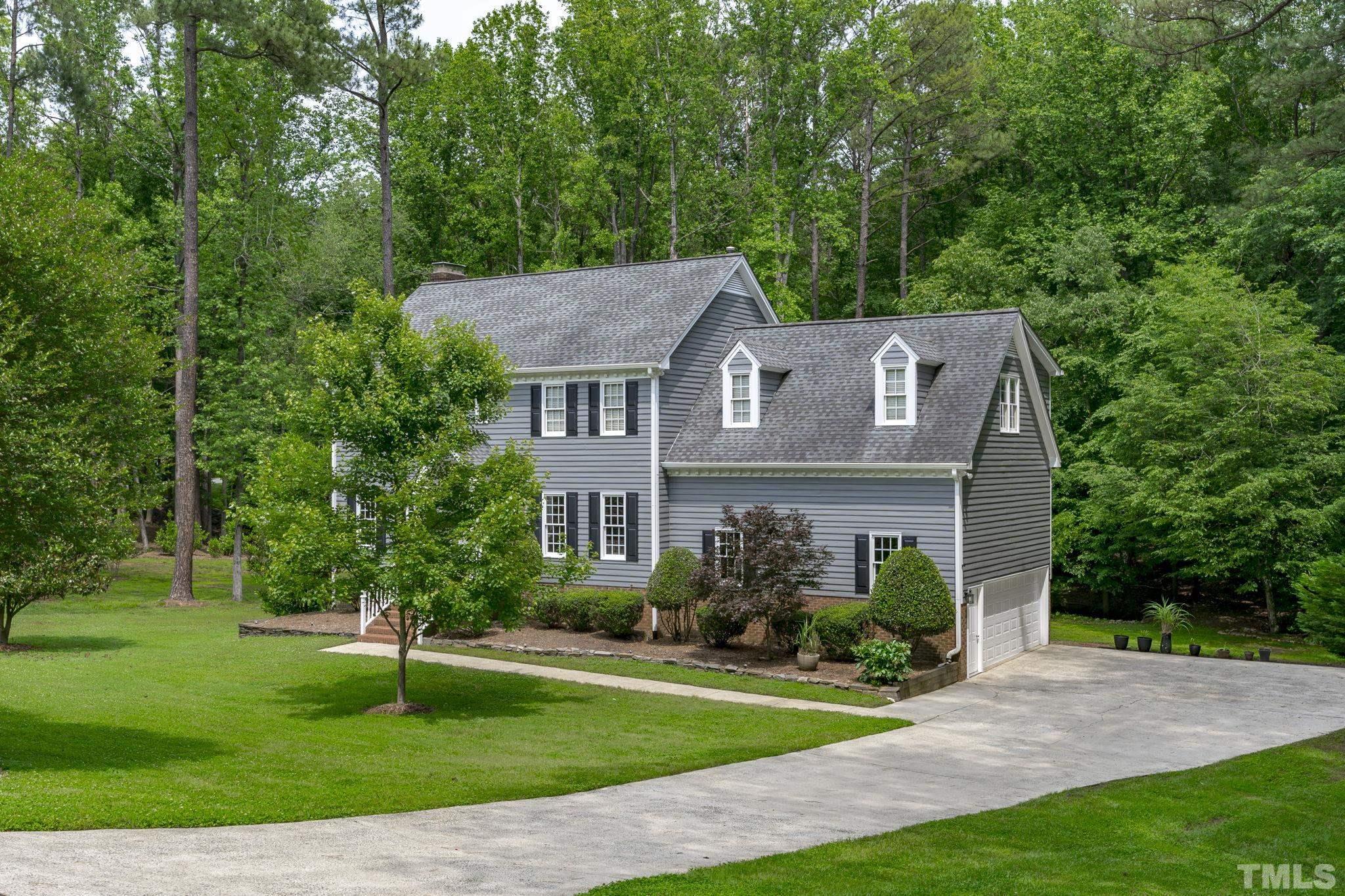 2821 Patrie Place Raleigh, NC 27613 - Photo 6 of 62 a aerial view of a house next to a big yard and large trees